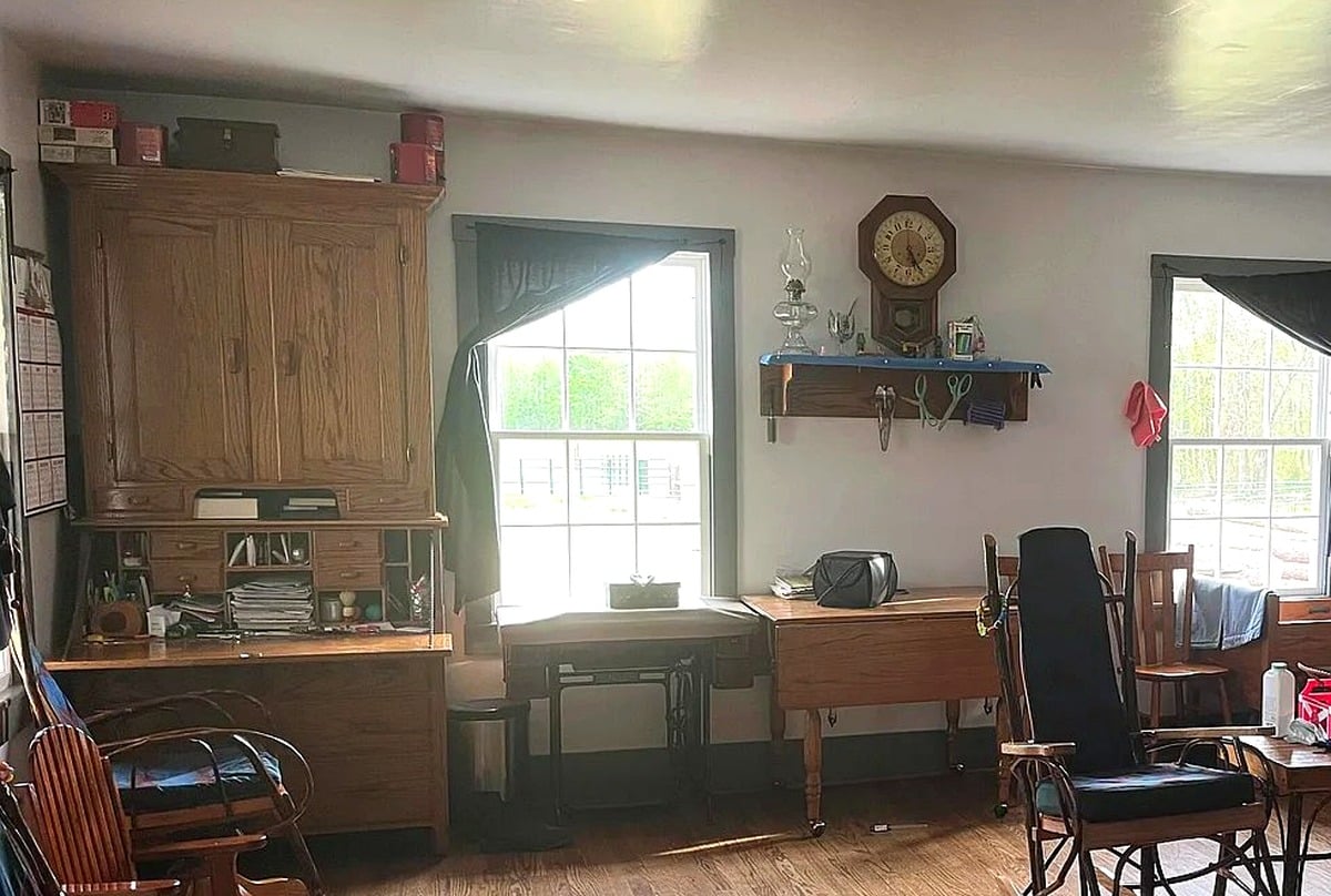 Wall clock, oil lamp, and desk hutch detail in a Swartzentruber Amish home in Mississippi
