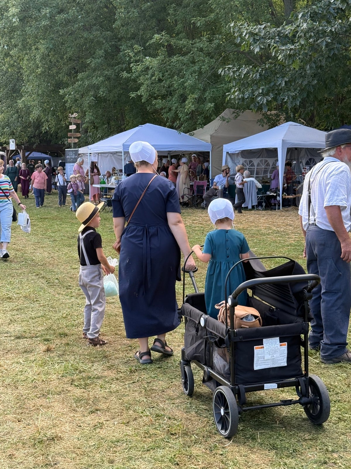 Amish mother with two children and a wagon stroller at Rentown Old Fashion Days