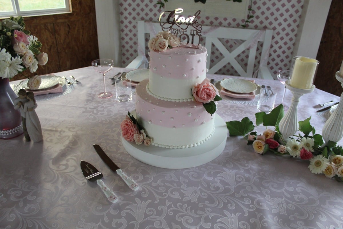 Pink and white tiered wedding cake with a God Gave Me You topper