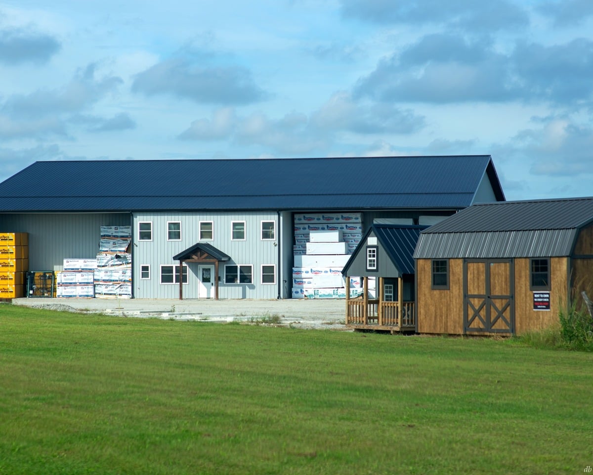 Portable buildings and lumber outside a building supply