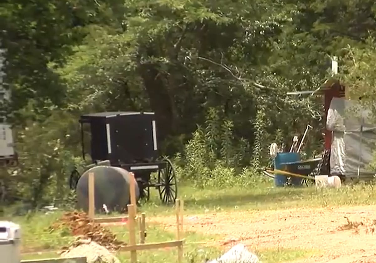 Swartzentruber Amish buggy parked beside a tank and construction materials at a new Amish homestead in Prentiss County, Mississippi