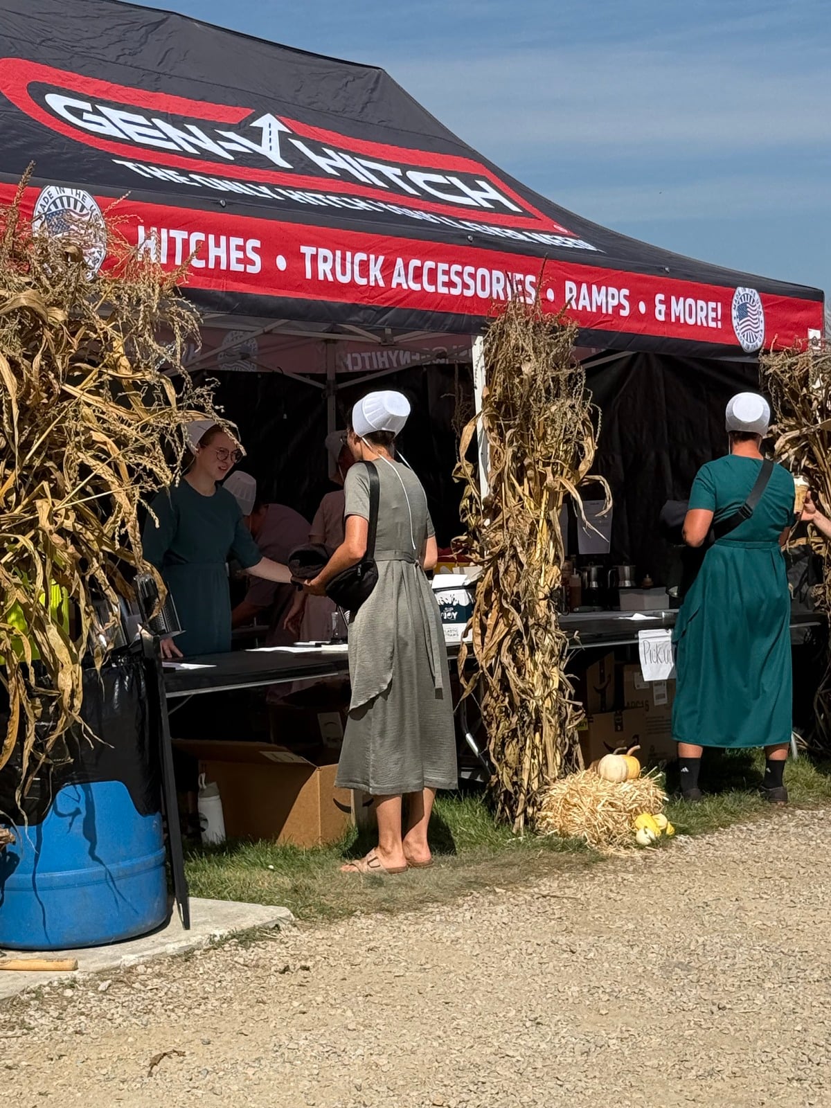 Amish women at a stand under the Gen-Y Hitch tent at Rentown Old Fashion Days