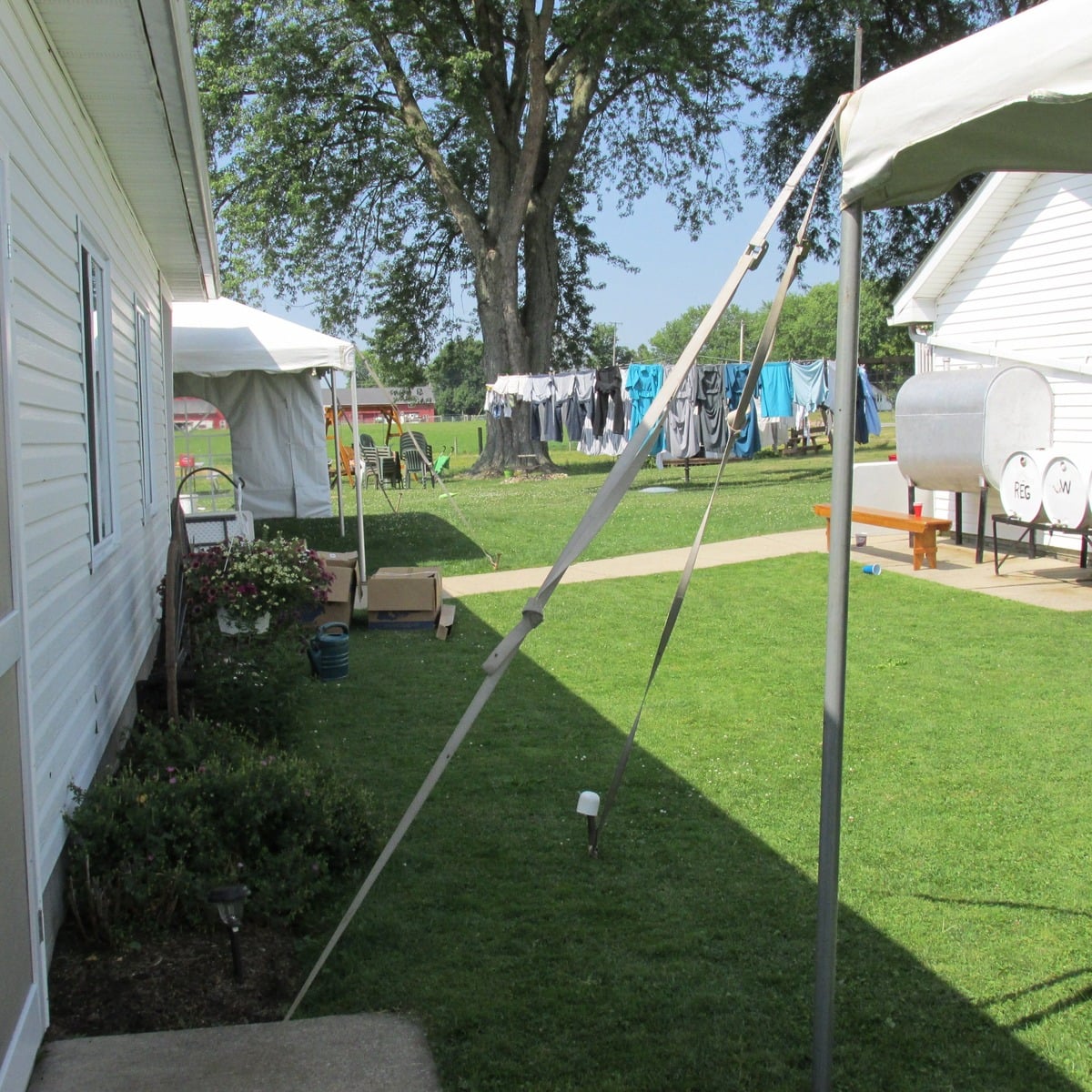 Tents set up in the yard beside an Amish home for a wedding