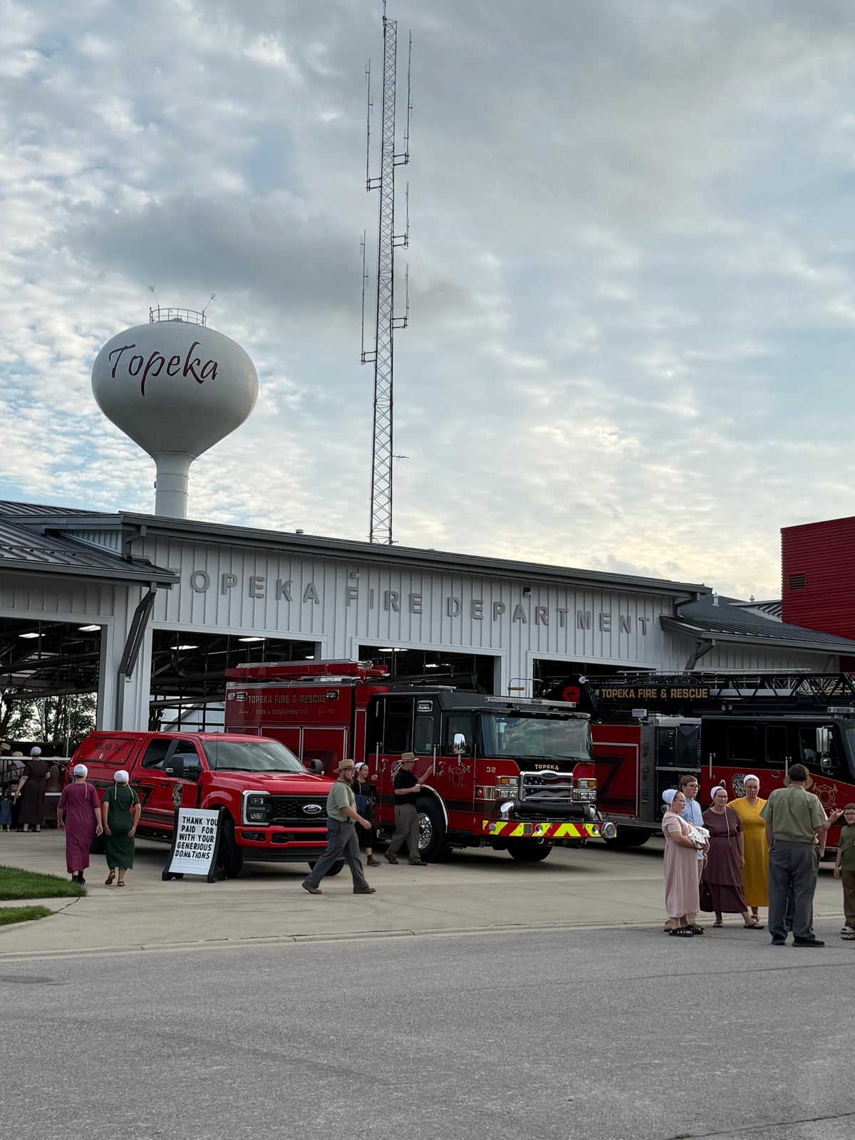 Topeka water tower above the Topeka Fire Department with Amish visitors out front