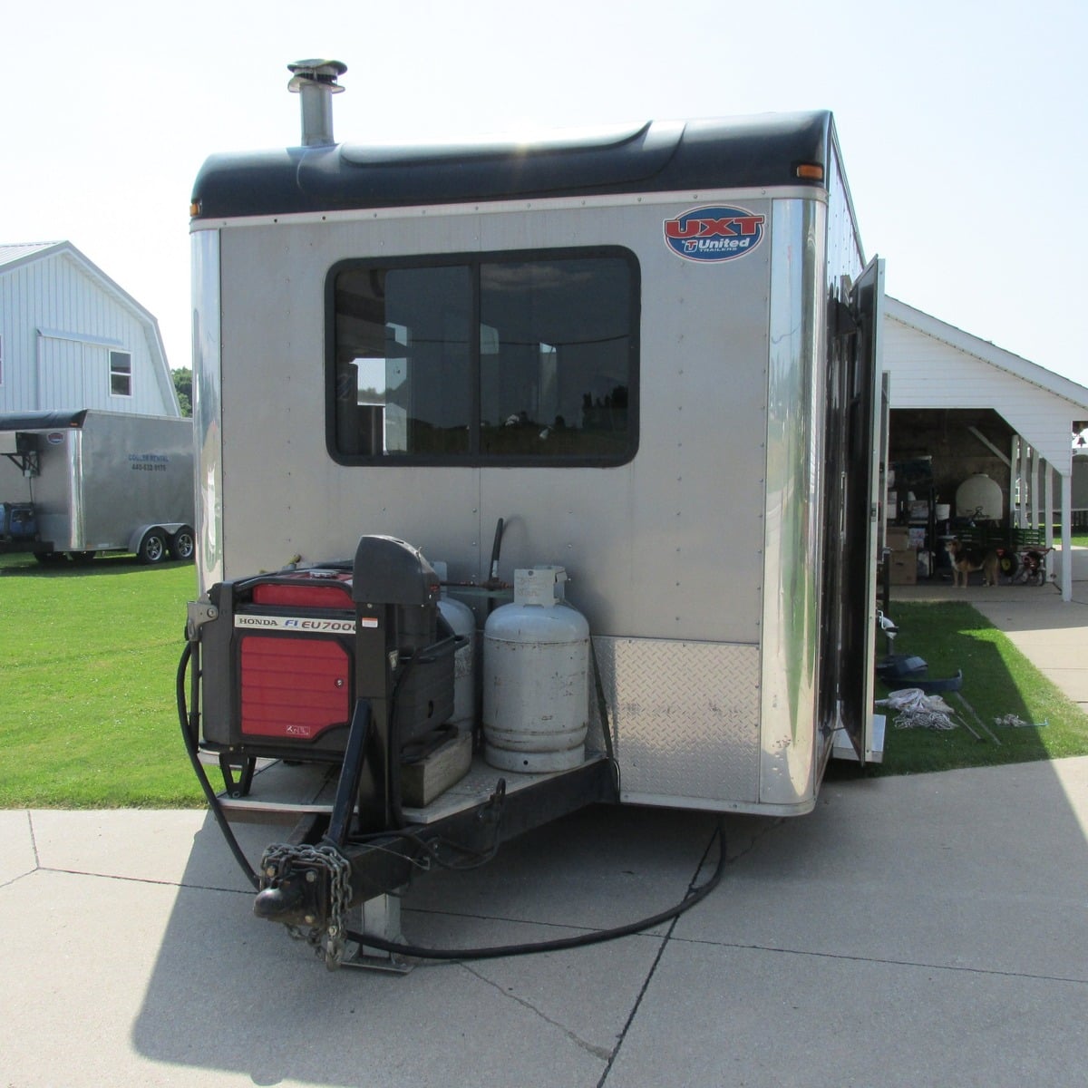 Trailer with a generator and propane tanks parked at an Amish wedding