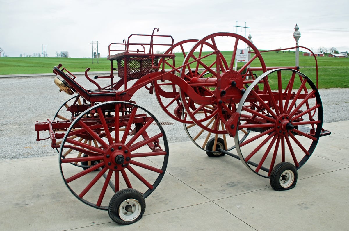 Red Cooney hose cart and reel outside the Weaver Wagons shop before restoration