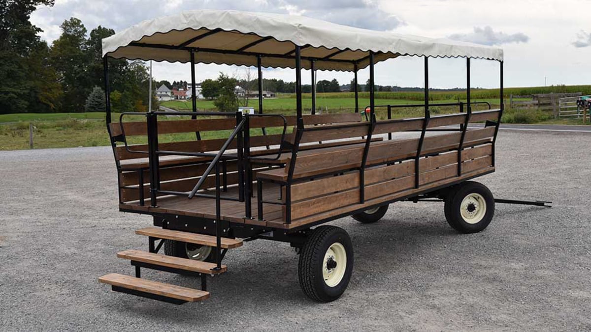 Canopied People Hauler wagon with wooden bench seating and boarding steps