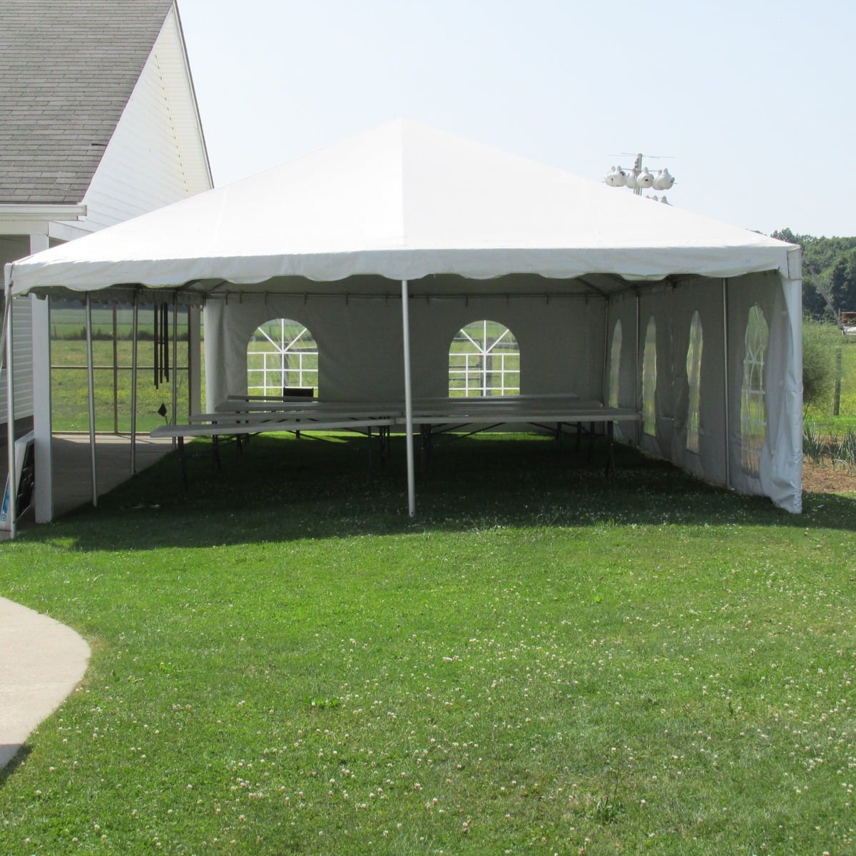 White event tent on the lawn at an Amish wedding